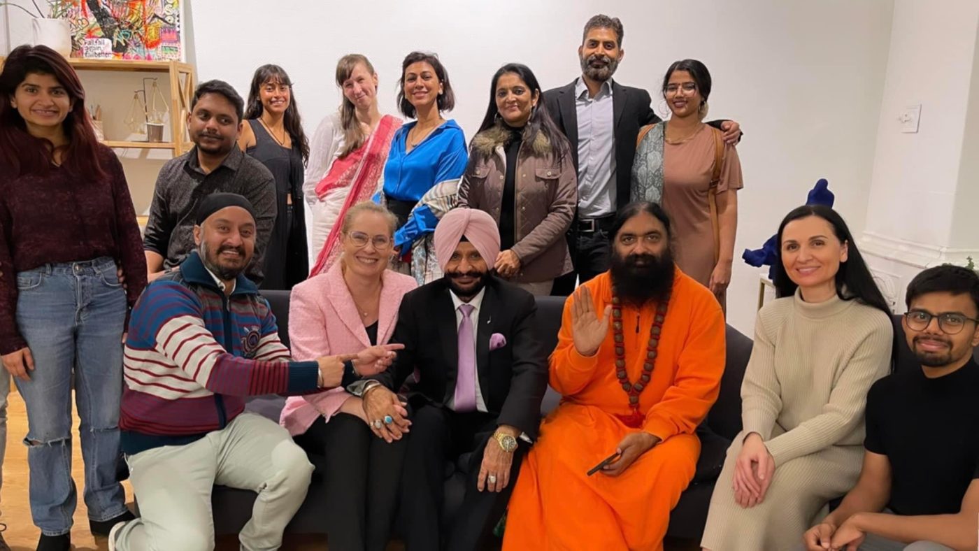 Swami Aditya with a gathering of students and guests