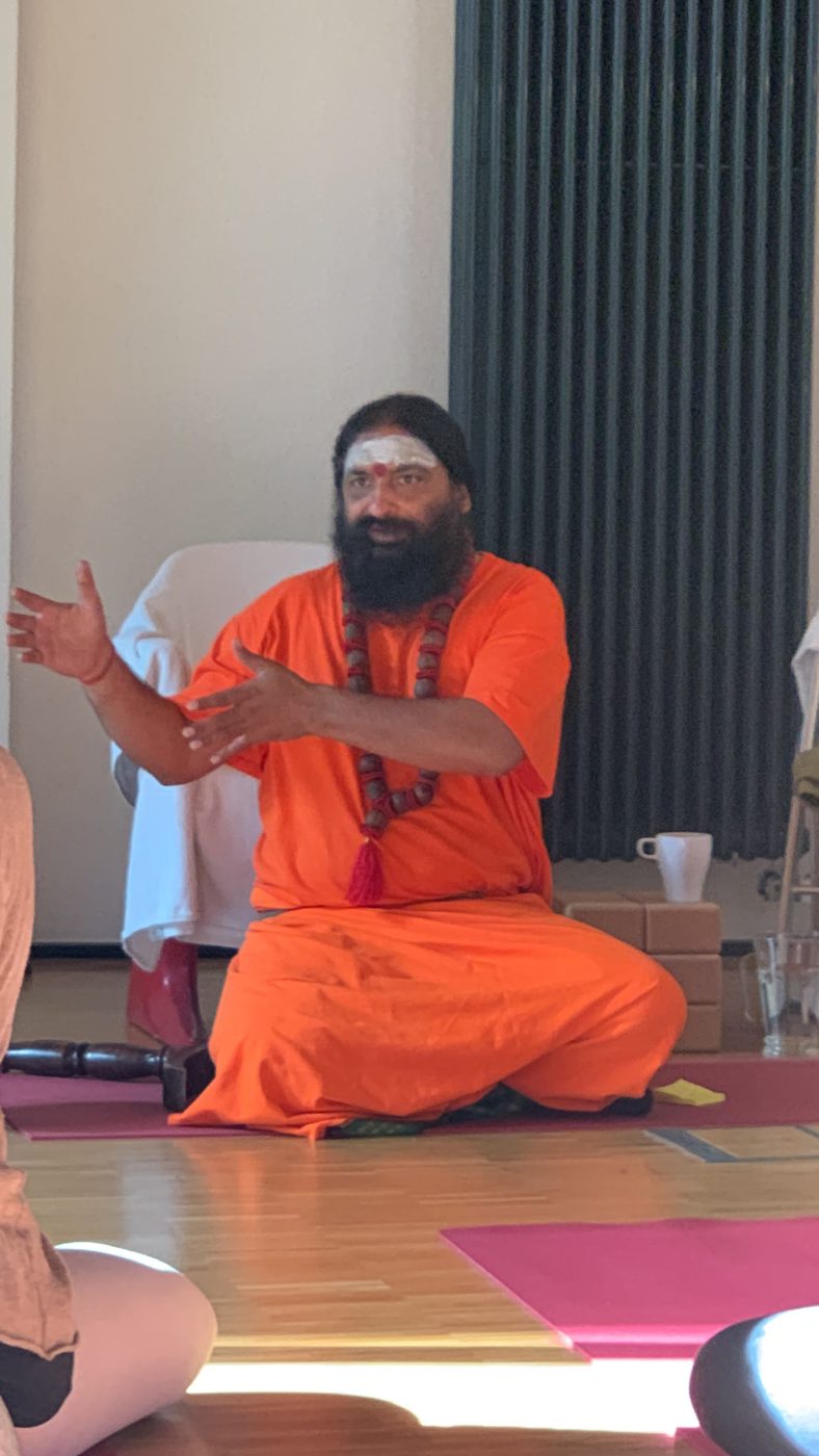 Swami Aditya guiding students in a teaching session